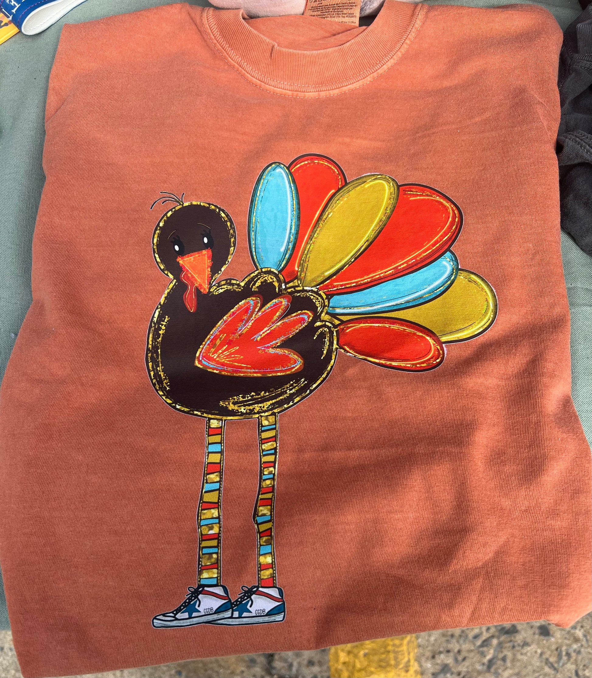 Yam colored Tshirt with a colorful turkey design 