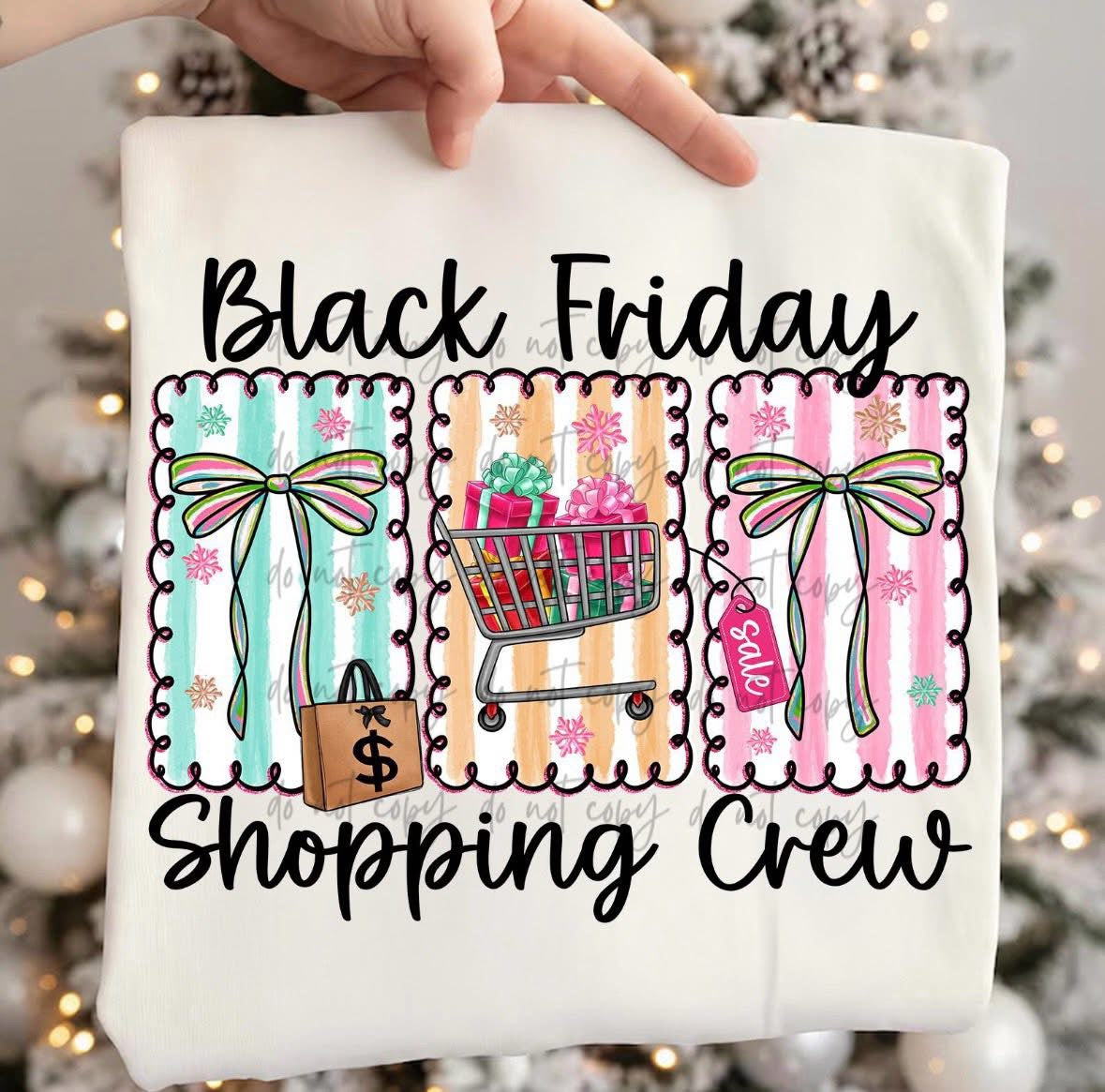 T-shirt with 'Black Friday Shopping Crew' design featuring shopping cart and bows against a blurred festive background.