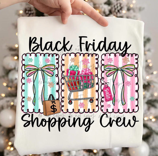 T-shirt with 'Black Friday Shopping Crew' design featuring shopping cart and bows against a blurred festive background.