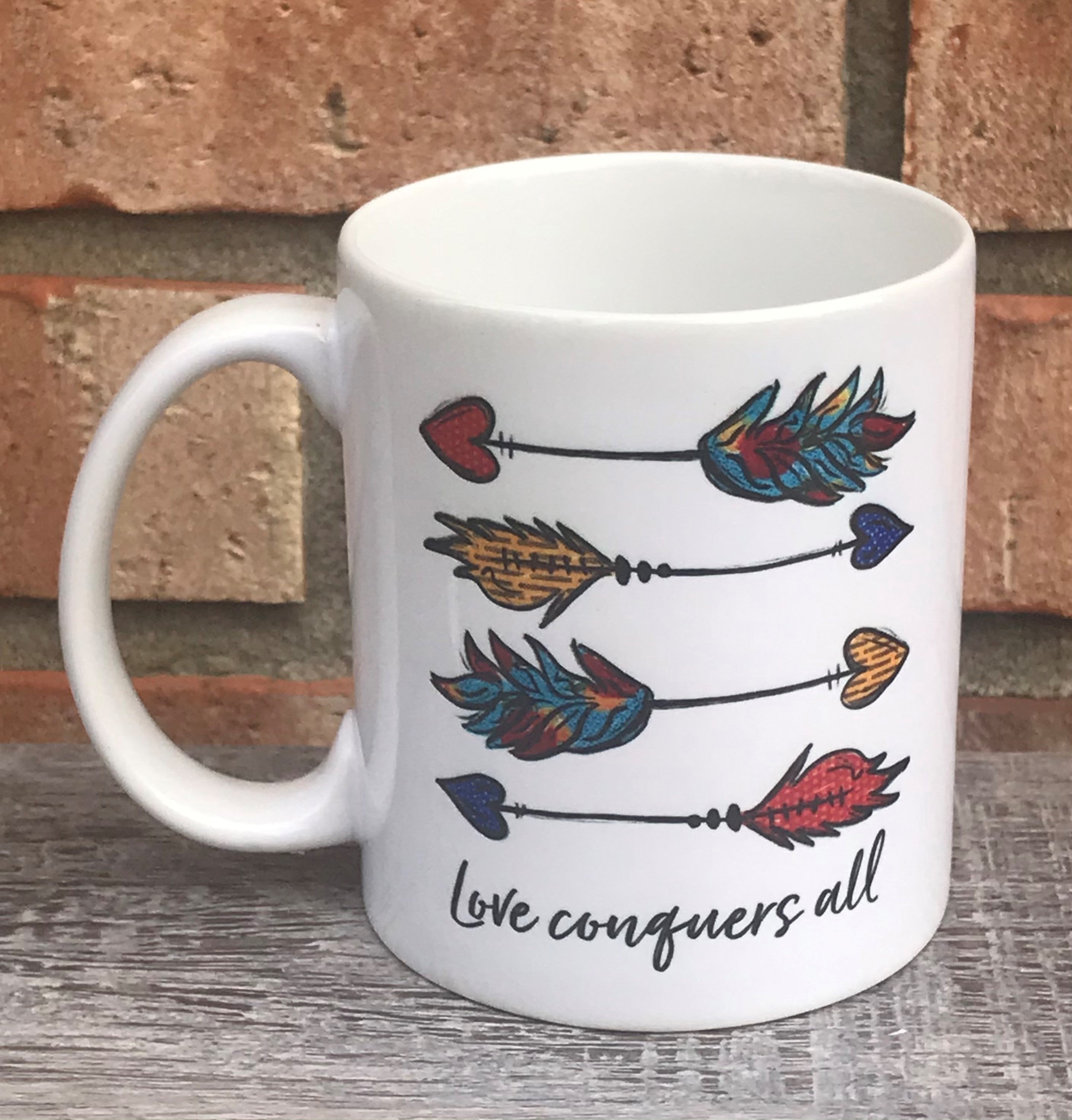 Love conquers all arrows mug